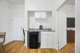 Located at 729 S Union Ave, Unit 109 in Los Angeles, CA, this 300-square-foot, one-bedroom, one-bathroom apartment is designed for efficient urban living. The unit features warm-toned hardwood flooring throughout, crisp white walls, and tall ceilings that enhance the sense of openness. The living area flows seamlessly into a recessed kitchenette alcove, equipped with white cabinetry, a tiled backsplash, a countertop with sink, and space for a compact refrigerator. The 140-square-foot bedroom includes a window with vertical blinds offering natural light and outdoor views, a closet, and direct access to the bathroom. A wall-mounted radiator provides in-unit heating. The bathroom is accessible from the bedroom and features a clean, functional layout. Additional storage is provided by a dedicated closet. The unit's straightforward, uncluttered design makes it a practical option for individuals seeking a manageable living space in the heart of Los Angeles.