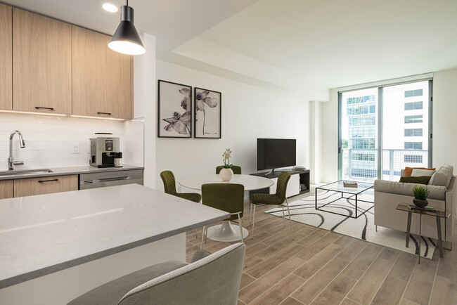 Dining and living room with hard surface flooring - Avalon Merrick Park