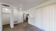 Located at 117 W William Cannon Dr in Austin, TX, this single-floor unit offers a straightforward and functional layout designed for comfortable everyday living. Throughout the space, dark hardwood-style flooring provides a warm, cohesive aesthetic that contrasts cleanly with the bright white walls and textured ceilings.

The open living area is airy and well-lit, benefiting from natural light streaming through blinded windows. A ceiling fan adds practical comfort to the space. The living area connects seamlessly to the kitchen via a pass-through breakfast bar, making the layout feel open and connected.

The kitchen is efficiently designed with white cabinetry, stainless steel appliances including a full-size refrigerator and gas range with overhead microwave, and a window that brings in natural light. Counter space is thoughtfully arranged to maximize utility in a compact footprint.

A walk-in closet provides generous storage, accessible directly from the main living space. The bathroom features a white vanity with a speckled countertop, a large mirror with vanity lighting above the sink, and clean white cabinetry. The overall design of the bathroom is simple and functional.

This unit's clean, neutral palette and consistent flooring throughout make it a versatile and move-in ready space in a convenient Austin location.