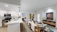 Located at 1640 E T C Jester Blvd in Houston, TX, this single-story, 3-bedroom, 2-bathroom home offers a thoughtfully designed open-concept layout that maximizes every inch of living space. Wood-look flooring flows seamlessly throughout, complementing the crisp white walls and crown molding that lend a clean, modern aesthetic.

The kitchen is a standout feature, showcasing white shaker cabinetry, quartz countertops, stainless steel appliances, and a breakfast bar with pendant lighting — all opening directly to the dining and living areas, making it ideal for entertaining. The living room is bright and welcoming, with natural light filtering in through large windows and a private entrance door.

The primary bedroom offers a generous footprint with a ceiling fan and sliding glass doors that lead to a private outdoor balcony. Both bathrooms are finished in white tile with matte black fixtures, featuring tub-shower combinations for a cohesive, contemporary look. Closets with built-in shelving provide practical storage throughout.

The dining area connects smoothly to a hallway that leads to the additional bedrooms and a dedicated laundry space. Crown molding, recessed lighting, and consistent finishes tie the entire home together, creating a comfortable and stylish living environment.