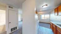 Located at 2537 Kelly St in Hayward, California, this two-bedroom, one-bathroom home offers a practical and comfortable single-floor layout. The living room serves as a welcoming centerpiece, featuring soft carpet, a classic brick fireplace, and a sliding glass door that opens to a private balcony with open views of the surrounding neighborhood and mature trees — bringing in generous natural light.

The galley-style kitchen is efficiently designed with warm wood cabinetry lining both walls, light-toned countertops, a white appliance suite including an electric range and refrigerator, and easy-care hard flooring. An adjacent dining area with a chandelier and a large window creates a pleasant space for meals.

Both bedrooms are carpeted and filled with natural light. The primary bedroom includes a closet with built-in shelving, while the second bedroom features a window overlooking the greenery outside. A shared hallway connects the rooms to the full bathroom, which is finished with wood-look flooring, a white vanity with a speckled countertop, and a tub-shower combination. Additional storage is available through a dedicated closet and hallway spaces. Textured ceilings are present throughout the home.