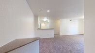 Located at 1070 Lake Front Dr in Sacramento, CA, this 2-bedroom, 2-bathroom residence offers a well-organized single-level layout designed for comfortable everyday living. The open-concept living and kitchen area serves as the heart of the home, where a peninsula-style counter with a granite-look surface separates the two spaces while maintaining a connected, airy feel. The kitchen is equipped with white cabinetry, a built-in microwave, an electric range, and a full-size refrigerator, all set on tile flooring. The living area features soft wall-to-wall carpeting and neutral white walls that lend a clean, bright ambiance throughout.

The primary bedroom is a generous retreat with a ceiling fan and light fixture, carpeted floors, and a sliding glass door leading to a private balcony with outdoor views of the surrounding community. The second bedroom benefits from a large picture window that fills the room with natural light and frames views of mature trees and communal amenities below. Both rooms are well-proportioned with ample wall space.

The bathrooms feature tile flooring, wide vanities with extended countertops, under-sink cabinetry, and large mirrors with overhead lighting. The overall design is functional and understated, providing a comfortable and practical living environment.