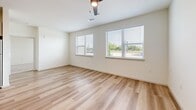 Located at 10001 Cedar Creek Dr in Sherman, Texas, this one-bedroom, one-bathroom residence offers a thoughtfully designed single-floor layout with a clean, modern aesthetic. The open-concept kitchen and living area serves as the heart of the home, featuring light wood-style flooring that flows seamlessly throughout the main living spaces. The kitchen is well-appointed with light wood cabinetry, granite-look countertops, and a full suite of stainless steel appliances including a refrigerator, range, microwave, and dishwasher — ideal for everyday cooking and entertaining. The living area is bright and airy, with multiple windows fitted with horizontal blinds that invite natural light while maintaining privacy, complemented by a ceiling fan overhead. The spacious primary bedroom features soft wall-to-wall carpeting, a ceiling fan with light, and a window with outdoor views, creating a comfortable and restful retreat. A dedicated closet provides ample storage. The bathroom is finished with a granite-top vanity, light wood cabinetry, a full soaking tub with shower, and wood-style flooring, maintaining the cohesive design language found throughout the home. Neutral wall tones and consistent finishes lend the entire space a clean, move-in-ready appeal.