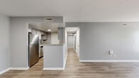 Located at 2765 Coldstream Lane in Columbus, Ohio, this single-floor, 2-bedroom, 4-bathroom home offers a clean, modern aesthetic throughout. The open living room is bright and welcoming, featuring warm luxury vinyl plank flooring, neutral gray walls, and multiple windows that draw in natural light. The kitchen is thoughtfully designed with granite countertops, gray shaker-style cabinetry, a gas range, and a tile backsplash accent — combining style and functionality in a compact, efficient layout. A pantry door adds convenient storage within the kitchen. The hallways connect spaces seamlessly, with LVP flooring continuing the cohesive design language. The bedrooms are carpeted for comfort, each featuring soft gray walls and ample closet space — the primary bedroom includes a double sliding-door closet. The four bathrooms are well-finished, featuring granite-topped vanities with gray cabinetry and LVP flooring. White panel doors with arched detailing are found throughout, adding a subtle architectural touch. The overall palette of soft grays and warm wood tones creates a clean, neutral, and move-in-ready environment suited for comfortable everyday living.