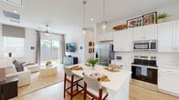 Located at 1841 Mansfield Webb Rd in Arlington, TX, this well-appointed single-story home offers 2 bedrooms, 3 bathrooms, an office, and a thoughtfully designed open floor plan. Light wood flooring flows throughout, lending the interior a clean, cohesive aesthetic.

The kitchen is a standout feature, boasting crisp white shaker cabinetry, quartz countertops, stainless steel appliances, and a central island with seating for four beneath elegant glass pendant lights. It connects seamlessly to the living room, which is brightened by large sliding glass doors that open to a private, fenced backyard with a lush green lawn — ideal for outdoor relaxation.

The primary bedroom is a comfortable retreat with natural light from well-dressed windows, while its en suite bathroom features a dual-sink vanity with white cabinetry and a spacious walk-in shower enclosed in floor-to-ceiling tile and glass. The second bedroom offers similar warmth and natural light, with its own closet and convenient bathroom access. A dedicated office provides a quiet space for work or study. Two closets add practical storage throughout. The home's bright white walls, recessed lighting, and ceiling fans contribute to a fresh, modern ambiance suited for comfortable everyday living.