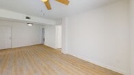 Located at 12375 SW 18th St in Miami, FL, this well-appointed 2-bedroom, 2-bathroom residence offers a clean, modern aesthetic throughout its single-floor layout. Light wood laminate flooring flows seamlessly across the living room, bedrooms, and hallways, creating a warm and cohesive feel. The spacious living room is a standout feature, filled with natural light streaming through a large sliding glass door that opens to an outdoor area with green views, complemented by a ceiling fan overhead. The kitchen is thoughtfully updated with light flat-panel cabinetry, stone countertops, a subway-tile backsplash, and white GE appliances including a range, microwave, and dishwasher. Both bedrooms are generously sized, bright, and airy, each featuring windows that frame pleasant outdoor greenery. The primary bedroom includes a dedicated closet with built-in storage. Both bathrooms have been renovated with white tile, stone-topped vanities, and sleek sliding glass enclosures — one featuring a tub-shower combination and the other a walk-in shower with warm mosaic tile flooring. Textured ceilings and crisp white walls throughout lend the space a clean, move-in-ready character well-suited to Miami living.