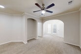 This 650 square foot single-story residence in Richmond, TX offers a well-designed living space with two bedrooms and one bathroom. The primary bedroom, measuring 140 square feet, provides ample space for comfort. The home features a modern kitchen with granite countertops, stainless steel appliances, and white cabinetry, complemented by hardwood flooring. The bathroom showcases a tiled design with a checkered pattern accent and a combination tub-shower. Both bedrooms are carpeted and include closet space, with one room featuring dual windows for natural light. The property includes a dedicated laundry area with full-sized washer and dryer. Throughout the home, neutral tones dominate, creating a bright and airy atmosphere. Crown molding adds a touch of elegance to the living spaces. The efficient floor plan maximizes the use of available space, making this compact home feel larger than its square footage suggests. With its updated finishes and practical layout, this property offers a comfortable living environment in a desirable location.