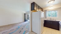 Located in the vibrant Normal Heights neighborhood of San Diego, this freshly renovated single-floor residence at 4598 N 39th St offers a clean, modern aesthetic throughout. New light-toned luxury vinyl plank flooring flows seamlessly across the living areas and bedrooms, lending a bright, cohesive feel to the entire space.

The kitchen has been thoughtfully updated with dark cabinetry extending to the ceiling for ample storage, striking quartz countertops with subtle veining, and white appliances including a full-size refrigerator and electric range with an over-the-range microwave. The layout connects naturally to the main living area, which features a sliding glass door opening to a private balcony with lush tree views.

Multiple bedrooms offer clean white walls, new flooring, and generous natural light through large windows dressed with vertical blinds. Ceiling fans are installed in select rooms for added comfort. The bathrooms have been refreshed with light tile flooring, dark vanity cabinetry, white countertops, and walk-in shower stalls with built-in shelving and chrome fixtures. Windows in the bathrooms allow for natural ventilation. The overall ambiance is bright, neutral, and move-in ready, reflecting a thorough and detail-oriented renovation throughout.