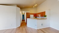 Located at 9101 N Coursier Ln in Spokane, WA, this single-floor, 3-bedroom, 2-bathroom residence offers a well-organized and functional layout. The open-concept kitchen and living area serves as the heart of the home, featuring warm wood cabinetry, a peninsula counter, tile backsplash, track lighting, and light hardwood flooring that flows throughout the main living spaces. The kitchen is equipped with white appliances and ample upper and lower cabinet storage.

A long hallway connects the living area to the three bedrooms, two full bathrooms, and dedicated laundry room. The bedrooms are carpeted and filled with natural light from windows with outdoor views of surrounding greenery, complemented by baseboard heating. The spacious primary bedroom includes a generous walk-in closet outfitted with wire shelving and hanging rods.

The bathrooms are clean and functional, each featuring a full tub/shower combination, wood-toned vanity cabinetry, and light flooring. The in-unit laundry room accommodates a full-size washer and dryer side by side, with overhead wire shelving for additional storage. The bright living room benefits from a sliding glass door that invites natural light and outdoor views, completing this practical and comfortable Spokane residence.