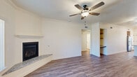 Located at 7355 N Willow Ave in Fresno, CA, this well-appointed single-story, 2-bedroom, 1-bathroom home offers a thoughtfully designed layout across a comfortable footprint. The living room serves as the heart of the home, featuring crown molding, a ceiling fan, hardwood-style flooring, a sleek fireplace with a granite hearth, and built-in shelving. Natural light flows in through a front-facing window, complementing the bright, neutral color palette throughout.

The combined dining and kitchen area is both functional and stylish, showcasing rich wood cabinetry, granite countertops, stainless steel appliances, recessed lighting, and a peninsula with bar seating — ideal for casual dining. A dedicated pantry adds convenient storage.

Both bedrooms are carpeted and include ceiling fans, with the primary bedroom offering a generous layout. The shared bathroom impresses with a wide granite-topped vanity, warm wood cabinetry, modern fixtures, and hardwood-style flooring.

Additional highlights include a dedicated laundry room with washer and dryer, a patio for outdoor enjoyment, ample closet space throughout, and an attached two-car garage with an automatic opener. Crown molding and consistent finishes lend a cohesive, polished feel to the entire home.