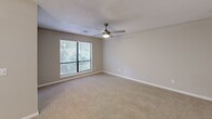 Located at 6300 Milgen Rd in Columbus, Georgia, this single-floor residence offers a thoughtfully organized layout across a comfortable footprint. The combined kitchen and living area forms the heart of the home, where the kitchen stands out with white cabinetry, light countertops, stainless steel appliances including a refrigerator and electric range, and wood-look flooring. A pass-through counter connects the kitchen to the living space, creating an open, connected feel. A separate pantry provides additional storage convenient to the kitchen.

The spacious bedroom features soft carpeting, neutral gray walls, a ceiling fan with light fixture, and a generous window overlooking lush greenery, filling the room with natural light and outdoor views. A dedicated closet serves the bedroom with wire shelving for organized storage.

The bathroom is clean and functional, equipped with a full tub-shower combination. A separate laundry room includes washer and dryer hookups — both electric and water connections — along with overhead wire shelving, adding practical utility to the home.

Throughout the residence, textured ceilings, neutral tones, and consistent finishes create a cohesive and comfortable living environment suited for everyday living.