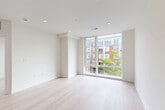 Located in Washington, DC's Kennedy Street corridor, this modern two-story residence offers a thoughtfully designed layout spread across two floors. The main level features an open-plan living, dining, and kitchen area filled with natural light, complemented by light-toned hardwood flooring that runs throughout the home. Recessed lighting adds a clean, contemporary finish to the bright white interiors.

The two bedrooms are well-proportioned and bathed in natural light, thanks to expansive floor-to-ceiling windows and oversized standard windows that frame views of the surrounding neighborhood. The primary bedroom is notably spacious and benefits from generous closet storage. A second bedroom includes a built-in closet with sliding doors. Both rooms carry the same light hardwood flooring and crisp white walls, contributing to a cohesive, airy aesthetic.

The two full bathrooms are finished with vertically laid white subway tile in the tub-shower surrounds, brushed nickel fixtures, and large-format hexagonal floor tile in a slate gray tone, paired with warm wood vanities and white countertops.

A standout feature is the private rooftop deck, accessible from the upper floor, offering open-air outdoor space with wood-toned composite decking and views across the DC skyline. In-unit laundry and multiple closets add practical convenience throughout.
