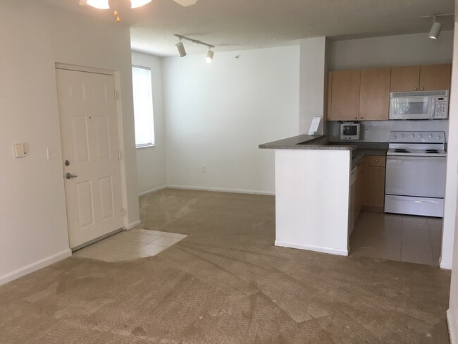 Building Photo - Great first floor corner unit, gated commu...