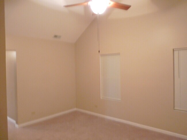 Living Room w/Cathedral Ceiling - 1236 S Washington St Apartments