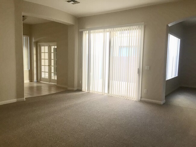 view from living room to courtyard between office and dining room - 1817 E Glacier Pl