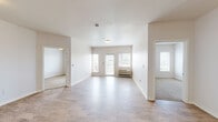 Located at 12201 Washington Center Pkwy in Thornton, Colorado, this two-bedroom, one-bathroom residence offers a functional and well-organized single-floor layout. The open-concept living and kitchen area is finished with light wood-style flooring that extends throughout the main living spaces, creating a clean and cohesive feel. Large windows and a glass balcony door flood the living room with natural light and provide outdoor views, while a wall-mounted HVAC unit ensures year-round comfort.

The kitchen is equipped with light wood cabinetry, ample upper and lower storage, a full suite of black appliances including a range, dishwasher, and refrigerator, and a breakfast bar peninsula that separates it from the living area. An electrical panel is conveniently recessed into the kitchen wall.

Both bedrooms feature plush carpeting, white walls, and window blinds for privacy. The primary bedroom includes a sliding-door closet for storage, while the second bedroom benefits from baseboard heating and natural light. The full bathroom is outfitted with warm wood cabinetry, a single-sink vanity with a countertop, a lighted mirror, and wood-style flooring. A dedicated closet rounds out the storage offerings in this straightforward and practical Thornton residence.