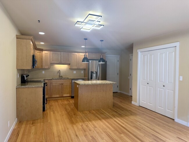 The kitchen with pantry and access to the garage - 210 NW 1st St