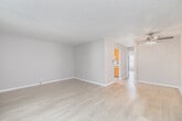 Located along North Pacific Coast Highway in Hermosa Beach, California, this one-bedroom, one-bathroom unit offers a practical and comfortable single-floor layout. The living room is bright and open, featuring light wood laminate flooring, neutral warm-toned walls, a textured ceiling, and a ceiling fan. Vertical blinds cover a large window, allowing natural light to fill the space. The entryway transitions seamlessly into the living area via tile flooring at the front door.

The galley-style kitchen is efficiently designed with warm wood cabinetry, a mosaic tile backsplash, tile flooring, a gas range, refrigerator, dishwasher, and a window that brings in additional natural light.

The bedroom is a comfortable size, with light wood flooring, neutral walls, and a full wall of mirrored sliding closet doors that enhance the sense of space. An additional walk-in closet offers extra storage. The bathroom features large-format tile flooring, a tub-shower combination with decorative mosaic tile accents, a vanity with under-sink storage, and a well-lit mirror. The overall ambiance throughout the unit is clean, neutral, and move-in ready, offering a functional coastal living experience in one of the South Bay's most desirable beach communities.