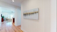 Located along Ridge Road in Plainfield, Illinois, this two-story space offers a thoughtfully designed interior with consistent hardwood flooring throughout the main living areas, creating a warm and cohesive aesthetic. A welcoming hallway adorned with decorative wall art leads into the heart of the space, setting an inviting tone upon entry.

The kitchen is a functional highlight, featuring rich cherry wood cabinetry, granite countertops, stainless steel appliances including a gas range and built-in microwave, and a generous island with pendant lighting. The layout flows naturally toward a bright dining area framed by vertical blinds that filter abundant natural light.

The living room is spacious and well-lit, with multiple windows on two walls, recessed lighting, and a ceiling fan. Its open feel makes it well-suited for both relaxing and entertaining.

The bedroom is comfortably sized with dual windows providing natural light and hardwood flooring. The bathroom is finished with marble-style tile flooring, a sleek dual-sink vanity with gold hardware, and a glass-enclosed tub-shower combination with tile surround.

An attached garage with an automatic opener provides secure, convenient parking. The overall design is clean, modern, and well-maintained throughout.