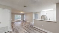 Located at 17900 NE 31st Ct in Aventura, Florida, this single-story, 3-bedroom, 2-bathroom home offers a clean, modern aesthetic throughout. Light wood-style flooring flows continuously across all rooms, complemented by neutral warm-beige walls, crisp white trim, and textured ceilings that lend a cohesive and polished look.

The kitchen is a standout feature, outfitted with white shaker-style cabinetry, quartz countertops, stainless steel appliances including a refrigerator, electric range, and dishwasher, and a peninsula that opens toward the living area — ideal for both daily use and entertaining.

Each of the three bedrooms is well-proportioned, with the primary bedroom offering generous closet space via double louvered bifold doors and a window with outdoor views. The secondary bedrooms each feature windows that bring in natural light and views of surrounding greenery.

Both bathrooms maintain a consistent, clean design with white vanities topped with quartz countertops, large mirrors with lighted fixtures above, and full tub-and-shower combinations with tiled surrounds and chrome accents.

Natural light is a recurring theme throughout the home, with multiple windows framing outdoor foliage and providing a bright, welcoming atmosphere across every room.