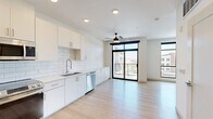 Located at 2515 S Verde Dr in Gilbert, AZ, this modern studio offers a thoughtfully designed single-floor layout that maximizes every square foot. The open-concept living and kitchen area is anchored by light-toned hardwood-style flooring that runs throughout, creating a seamless and cohesive feel.

The kitchen is well-appointed with white shaker cabinetry, a classic subway tile backsplash, light quartz countertops, and a full suite of stainless steel appliances including a refrigerator, range, microwave, and dishwasher. A ceiling fan overhead and recessed lighting keep the space comfortable and well-lit.

Floor-to-ceiling windows with bold black frames flood the living area with abundant natural light and offer elevated views of the surrounding Gilbert community. A sliding glass door opens to a private balcony, extending the living space outdoors.

The bathroom is clean and functional, featuring a single-sink vanity with modern hardware, a combination tub and shower, and wood-toned tile flooring. An adjacent walk-in closet provides dedicated storage space. The overall aesthetic is contemporary and minimal, with crisp white walls, modern fixtures, and an airy ambiance that makes the space feel open and inviting.