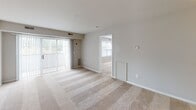 Located at 218 Bay Tree Rd in Dover, Delaware, this single-floor residence offers a thoughtfully laid-out interior with a clean, neutral aesthetic throughout. The open living area is finished with plush wall-to-wall carpeting and features a sliding glass door that fills the space with natural light and provides access to the outdoors. The layout flows seamlessly from the living area into the adjacent rooms, creating a cohesive and functional floor plan.

The kitchen is equipped with ample white cabinetry accented by warm wood trim, granite-style countertops, and black appliances including a refrigerator and dishwasher. Tile flooring adds durability and easy maintenance to this functional cooking space.

The bedrooms are generously proportioned, each featuring soft carpeting, neutral wall tones, and windows with blinds that allow for natural light while maintaining privacy. Views of the surrounding greenery are visible from several windows.

Two full bathrooms serve the residence, each finished with tile flooring and granite-style vanity countertops. One bathroom features a shower-tub combination with sliding glass doors, while the other includes a standalone shower enclosure, both with clean, classic fixtures. The overall ambiance of this residence is bright, neutral, and move-in ready.