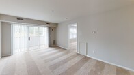 Located at 218 Bay Tree Rd in Dover, Delaware, this single-floor residence offers a thoughtfully laid-out interior with a clean, neutral aesthetic throughout. The open living area is finished with plush wall-to-wall carpeting and features a sliding glass door that fills the space with natural light and provides access to the outdoors. The layout flows seamlessly from the living area into the adjacent rooms, creating a cohesive and functional floor plan.

The kitchen is equipped with ample white cabinetry accented by warm wood trim, granite-style countertops, and black appliances including a refrigerator and dishwasher. Tile flooring adds durability and easy maintenance to this functional cooking space.

The bedrooms are generously proportioned, each featuring soft carpeting, neutral wall tones, and windows with blinds that allow for natural light while maintaining privacy. Views of the surrounding greenery are visible from several windows.

Two full bathrooms serve the residence, each finished with tile flooring and granite-style vanity countertops. One bathroom features a shower-tub combination with sliding glass doors, while the other includes a standalone shower enclosure, both with clean, classic fixtures. The overall ambiance of this residence is bright, neutral, and move-in ready.