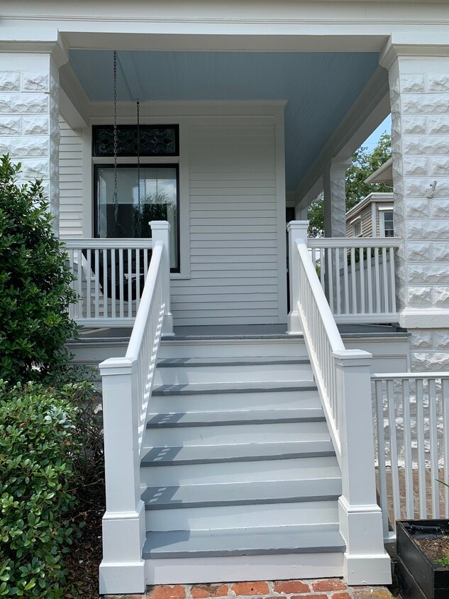Welcoming front porch with swing and attached driveway - 1316 Pleasant St