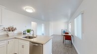 Located at 2727 Sixth St in Santa Monica, CA, this single-floor unit offers a clean, modern aesthetic with thoughtful finishes throughout. The open-concept kitchen is a standout feature, equipped with stainless steel appliances including a range, over-the-range microwave, and dishwasher, all complemented by crisp white shaker cabinetry, light quartz countertops, and a peninsula with an undermount sink that flows seamlessly into the living and dining area. The living space features light hardwood-style flooring and receives generous natural light through large windows. Two well-proportioned bedrooms each include ceiling fans with lighting and wide windows that frame views of surrounding greenery. The primary bedroom benefits from mirrored sliding closet doors and additional windows offering neighborhood views. The bathrooms are finished with modern touches, including undermount sinks set in quartz vanity tops, wall-mounted sconce lighting, and frameless mirrors. The primary bath features a fully tiled walk-in shower with a glass enclosure, while the second bath shares the same refined design language. The unit's consistent use of neutral tones and quality materials creates a cohesive, contemporary atmosphere throughout.