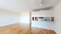 Located at 500 13th Street in Parkersburg, West Virginia, this single-floor, one-bedroom, one-bathroom unit offers a practical and well-organized layout. The open-concept living room is a standout feature, showcasing warm hardwood flooring that reflects natural light and a ceiling fan fixture overhead. A large sliding glass door fitted with vertical blinds floods the space with daylight and provides direct access to the outdoors. The kitchen is thoughtfully designed in a galley style, featuring rich wood cabinetry on both sides, light countertops, tile backsplash, a double-basin sink, an electric range, and a full-size refrigerator. A pass-through window connects the kitchen to the living area, enhancing the open feel of the shared space. The bedroom offers a cozy and private retreat, with dark laminate flooring, a sliding double-door closet, a window with natural views, and a wall-mounted air conditioning unit. The bathroom is neatly finished with beadboard wainscoting, a vanity with storage, and clean white fixtures. A utility room and dedicated closet space complete the functional layout of this compact yet complete unit.