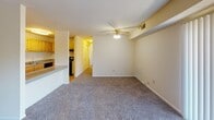 Located at 3404 Hewitt Ave in Silver Spring, Maryland, this ground-floor apartment offers a functional and comfortable single-level layout. The open living area is carpeted and bathed in natural light, featuring a ceiling fan and a pass-through counter that connects seamlessly to the kitchen. The kitchen is well-equipped with light wood cabinetry, granite-style countertops, a gas range, dishwasher, and hardwood flooring, providing ample storage and workspace. Two carpeted bedrooms each feature large windows with vertical blinds that allow for natural light and outdoor views. The primary bedroom stands out with double closets, offering generous storage capacity, while the second bedroom also includes closet space. The bathroom is neatly appointed with a granite-topped vanity, a large wall mirror, and a walk-in shower with sliding glass doors. Throughout the unit, neutral tones and clean finishes create a bright, move-in-ready atmosphere. The efficient floor plan maximizes usable space while maintaining a comfortable flow between living, dining, and sleeping areas, making this residence a practical choice in the Silver Spring community.