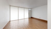 Located at 1386 Court Ave in Memphis, TN, this single-floor, one-bedroom, one-bathroom unit offers an efficient and well-appointed layout. The living room serves as the welcoming centerpiece of the space, featuring warm wood-look tile flooring that runs throughout the unit, clean white walls, and a textured ceiling. A wall of large windows and a glass panel entry door flood the area with natural light, creating an open and airy feel despite the compact footprint.

The kitchen is thoughtfully designed with crisp white shaker-style cabinetry extending to the ceiling for ample storage, a gray subway tile backsplash, stainless steel appliances including a refrigerator and range, and a double-basin sink — all combining to create a clean, modern aesthetic.

The bedroom is a comfortable size, offering a window with a view of the outdoors, continued wood-look tile flooring, warm wood baseboards, and a textured ceiling, providing a calm and neutral retreat.

The bathroom features floor-to-ceiling large-format marble-look porcelain tile in warm beige and taupe tones surrounding a full soaking tub and shower combo, giving the space a polished and upscale appearance. Throughout the unit, the consistent flooring and neutral color palette tie each room together cohesively.