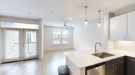Located at 800 West Pasadena Boulevard in Deer Park, Texas, this efficiently designed single-floor unit offers a thoughtfully arranged layout that maximizes every square foot. The entrance opens into a bright hallway with light wood-style flooring that flows throughout the space, flanked by two closets — one of which features multi-tier wire shelving for organized storage.

The open-concept living, dining, and kitchen area forms the heart of the unit. The kitchen is well-appointed with two-tone cabinetry — white upper cabinets paired with dark lower cabinets — complemented by quartz countertops, a stainless steel undermount sink, and a full suite of stainless steel appliances including a refrigerator, range, microwave, and dishwasher. Pendant lighting above the peninsula adds a contemporary touch. The living area benefits from a ceiling fan, recessed lighting, and windows that invite natural light, with access to a private balcony.

The bathroom features subway tile surrounding a soaking tub and shower combination, brushed nickel fixtures, and neutral tile flooring. A dedicated laundry area adds everyday convenience. The unit's clean, neutral palette and modern finishes create a cohesive, move-in-ready living environment.