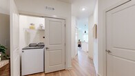Located at 411 Sage Rd N in White House, Tennessee, this well-designed 2-bedroom, 2-bathroom single-story home offers a thoughtfully planned open-concept layout that seamlessly connects the living, dining, and kitchen areas. Light hardwood-style flooring flows throughout the main living spaces, complemented by crisp white walls that create a bright, airy atmosphere.

The kitchen is a standout feature, boasting white shaker cabinetry with matte black hardware, granite countertops, a classic subway tile backsplash with under-cabinet lighting, and stainless steel appliances. The dining area opens directly to the outdoors through glass French doors, filling the space with natural light. The adjacent living room features large windows with exterior views and a ceiling fan overhead.

Both bedrooms are carpeted and generously sized, with the primary bedroom offering comfortable proportions and ample natural light. A spacious walk-in closet with wire shelving provides excellent storage. The two bathrooms are finished with granite vanities, white cabinetry, and tiled tub-shower combinations.

A dedicated laundry area with a full-size washer and dryer adds everyday convenience, while a hallway connects all areas of the home for an efficient, functional flow throughout.