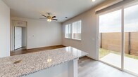 Located at 16336 Cameron Road in Pflugerville, Texas, this single-story home offers a thoughtfully designed layout with two bedrooms, two bathrooms, and two closets. Light-toned luxury vinyl plank flooring runs throughout, creating a cohesive and easy-to-maintain living environment.

The kitchen is a standout feature, showcasing white shaker-style cabinetry, granite countertops, stainless steel appliances including a refrigerator, range, microwave, and dishwasher, and a generous island with bar seating. The kitchen opens directly to the dining and living area, which benefits from natural light through large windows and a sliding glass door leading to an outdoor patio.

The primary bedroom includes a ceiling fan and connects to a well-appointed en suite bathroom featuring granite countertops, a single undermount sink, and a glass-enclosed walk-in shower with tile surround, alongside a dedicated walk-in closet. The second bedroom is bright and versatile, also equipped with a ceiling fan and a window overlooking the exterior. The second bathroom mirrors the refined finishes of the primary, with granite counters and a clean, neutral palette. Recessed lighting and consistent trim work complete the polished, move-in-ready aesthetic throughout the home.