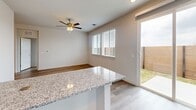 Located at 16336 Cameron Road in Pflugerville, Texas, this single-story home offers a thoughtfully designed layout with two bedrooms, two bathrooms, and two closets. Light-toned luxury vinyl plank flooring runs throughout, creating a cohesive and easy-to-maintain living environment.

The kitchen is a standout feature, showcasing white shaker-style cabinetry, granite countertops, stainless steel appliances including a refrigerator, range, microwave, and dishwasher, and a generous island with bar seating. The kitchen opens directly to the dining and living area, which benefits from natural light through large windows and a sliding glass door leading to an outdoor patio.

The primary bedroom includes a ceiling fan and connects to a well-appointed en suite bathroom featuring granite countertops, a single undermount sink, and a glass-enclosed walk-in shower with tile surround, alongside a dedicated walk-in closet. The second bedroom is bright and versatile, also equipped with a ceiling fan and a window overlooking the exterior. The second bathroom mirrors the refined finishes of the primary, with granite counters and a clean, neutral palette. Recessed lighting and consistent trim work complete the polished, move-in-ready aesthetic throughout the home.