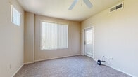 Located at 20050 N Cave Creek Rd in Phoenix, AZ, this single-story, one-bedroom, one-bathroom unit offers a practical and comfortable floor plan across a compact yet efficient footprint. The layout includes a living room, kitchen, bedroom, bathroom, closet, and hallway, providing a well-organized flow throughout the space.

The living room features soft wall-to-wall carpeting, a ceiling fan, and a large window dressed with vertical blinds that invite natural light. A secondary exterior door with a window adds additional brightness and access. The entry area opens to a carpeted main space with high transom windows that further enhance natural light.

The kitchen is equipped with light wood cabinetry, dark granite-style countertops, and a full suite of black appliances including a refrigerator, electric range, over-the-range microwave, and sink — all set on durable wood-look flooring.

The bedroom is a comfortable size, featuring plush carpeting, a ceiling fan, and a large window with vertical blinds offering natural views of the surrounding area.

The bathroom includes a full tub and shower combo with white tile surround, a dark granite-style vanity countertop, a large mirror, and wood-look flooring, delivering a clean and functional design. Neutral warm tones carry throughout the unit, creating a cohesive and inviting ambiance.