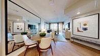 Located on iconic West Sunset Boulevard in Los Angeles, this thoughtfully designed one-bedroom, one-bathroom residence offers a smart, efficient layout across a single floor. The open-concept kitchen and living area forms the heart of the home, where light gray cabinetry, a white tile backsplash, and stainless steel appliances — including a gas range, microwave, and dishwasher — create a clean, contemporary kitchen. Light-toned hardwood flooring flows seamlessly throughout, connecting the kitchen to a dedicated dining area and into the spacious living room. A large floor-to-ceiling mirror amplifies the sense of space in the dining zone, while the living room benefits from a sliding glass door that opens to a private balcony, inviting natural light and outdoor views. The bedroom offers a comfortable retreat with direct access to a dedicated closet featuring built-in shelving and hanging storage. The bathroom is finished with large-format stone tile flooring, wood-look wall tile surround, and a full soaking tub. Recessed lighting throughout, neutral tones, and clean architectural lines contribute to a modern, cohesive ambiance well-suited to urban Los Angeles living.