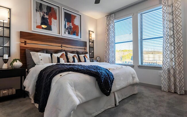 Well-Lit Bedroom Featuring Modern Décor and Ample Natural Light - The Harper
