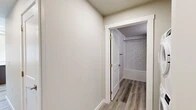Located at 508 W Sixth Ave in Spokane, WA, this one-bedroom, one-bathroom unit offers a thoughtfully designed layout that maximizes every square foot. Light-toned wood-look flooring flows consistently throughout the space, creating a cohesive and contemporary aesthetic.

The kitchen serves as a central highlight, featuring rich dark-stained cabinetry, white countertops, a stainless steel appliance suite including a refrigerator, range, microwave, and dishwasher, and a peninsula island that provides additional prep space and a natural divider between the kitchen and living area. Recessed lighting illuminates the space, while multiple windows invite natural light and views of the surrounding neighborhood.

The bedroom is a calm, neutral retreat with clean wall finishes and ample room for furnishings. Wood-look flooring continues here, maintaining the unit's consistent style.

The bathroom is well-appointed with dark wood cabinetry that mirrors the kitchen, a white countertop vanity, brushed nickel fixtures, and a full soaking tub and shower combination framed by classic white subway tile extending floor to ceiling. A hallway connects the living spaces efficiently, completing the unit's practical and polished layout.