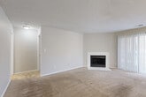 Located at 6609 Reafield Dr in Charlotte, NC, this well-appointed one-bedroom, one-bathroom residence offers a thoughtfully designed layout across a single floor. The open-concept living and kitchen area forms the heart of the home, with the living room featuring soft wall-to-wall carpeting, a textured ceiling, and a classic white-mantled fireplace that serves as a central focal point. Neutral tones throughout create a clean, versatile aesthetic.

The kitchen is efficiently laid out in a galley style, showcasing warm wood-look luxury vinyl plank flooring, crisp white cabinetry with modern hardware, a subway tile backsplash, and black stainless appliances including a range, dishwasher, and refrigerator — providing a functional and stylish cooking space.

The bedroom is generously sized and filled with natural light from multiple windows, including a sliding glass door fitted with vertical blinds that opens to an outdoor area. The bedroom connects to a walk-in closet outfitted with wire shelving for ample storage.

The bathroom is clean and functional, featuring a full tub-shower combo with white tile surround, a white vanity, and wood-look flooring. A dedicated in-unit laundry area with washer and dryer hookups adds everyday convenience, completing this practical and comfortable Charlotte residence.