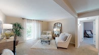 Located at 10304 Beau Jardin Dr in Saint Louis, Missouri, this single-floor residence offers a well-organized layout with a comfortable and cohesive design throughout. The spacious living room is a standout feature, showcasing neutral-toned walls, plush wall-to-wall carpeting, and a large sliding glass door that floods the room with natural light and provides views of the surrounding greenery. The open sightline from the living room connects seamlessly to the dining area, which is centered under a ceiling fan fixture and features enough space for a round dining table and chairs, creating an inviting setting for meals. The kitchen is equipped with warm wood cabinetry, a built-in microwave, electric range, and ample counter space, offering practical functionality. A dedicated office or flex room provides a quiet retreat, complete with a window for natural light and generous carpet space. The bedroom is well-proportioned with large windows dressed in sheer curtains, a ceiling fan, and soft carpeting, contributing to a restful atmosphere. The bathroom includes a full tiled tub-shower combination, tile flooring, and clean, classic finishes. A carpeted hallway with panel doors and built-in closet storage connects the private spaces, completing this thoughtfully laid-out single-level home.