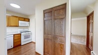 Located at 3017 33rd St S in La Crosse, Wisconsin, this two-story home offers four bedrooms and one bathroom spread across two well-proportioned floors. The layout is practical and efficient, with living and kitchen areas on the main floor and bedrooms distributed across both levels.

The kitchen is equipped with warm honey-toned wood cabinetry, a double-basin stainless steel sink, marble-patterned laminate countertops, and white appliances including a gas range with overhead microwave and a dishwasher. A window above the sink allows natural light to brighten the workspace. Distinctive six-panel wood doors with rich wood trim appear throughout the home, adding a consistent, classic character to each room.

The bedrooms are carpeted and feature neutral cream-toned walls, wood baseboard heating, and closets with matching six-panel bi-fold doors. Several bedrooms include ceiling fans with light fixtures and windows with vertical blinds that invite natural light. The generously sized primary bedroom provides ample space for comfortable furnishing.

The bathroom is clean and functional, featuring a full-size soaking tub with a tiled surround and built-in shelving niche. Baseboard heating is present throughout the home, and select rooms include wall-mounted air conditioning units. The overall ambiance is clean, understated, and move-in ready.
