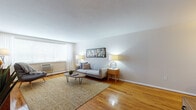 Located at 1244–1246 Farmington Ave in West Hartford, CT, this single-floor residence offers a thoughtfully designed layout that balances comfort and functionality. Rich hardwood flooring flows throughout the main living areas, lending warmth and continuity to the space.

The living room is bright and welcoming, featuring a large window with blinds and sheer curtains that allow generous natural light to fill the room. The space comfortably accommodates a seating area and an entertainment setup, with room for a dedicated work or media corner complete with shelving storage.

Adjacent to the living area is a compact dining nook with hardwood floors, which transitions smoothly into the kitchen. The kitchen is well-equipped with white cabinetry, dark countertops, white appliances including a full-size refrigerator and electric range, and tile flooring — offering an efficient and clean workspace.

The bedroom is generously proportioned, featuring a wide wall of louvered closet doors for ample storage, hardwood floors, and a window with patterned curtains that invite natural light and garden views. The room provides a calm and restful atmosphere.

The bathroom features white subway tile, a vanity with cabinet storage, a mirrored medicine cabinet, and a tub-shower combination. The overall design of the residence is clean and practical, making it a comfortable home in a convenient West Hartford location.