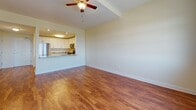 Located at 103 Patriot Dr in Middletown, Delaware, this single-floor residence offers a well-designed layout that balances functionality with comfort. Warm hardwood flooring runs consistently throughout the space, lending a cohesive and inviting feel to every room.

The kitchen is a standout feature, outfitted with crisp white shaker cabinetry, granite countertops, and a full suite of stainless steel appliances including a gas range, over-the-range microwave, dishwasher, and a large French door refrigerator. A pass-through opening connects the kitchen directly to the living area, creating an open, airy flow ideal for everyday living and entertaining.

The living area is generously proportioned, bathed in natural light from large double-pane windows dressed with blinds. A ceiling fan overhead adds to the room's comfort. The bedrooms continue the same hardwood flooring and bright, neutral palette, each equipped with ceiling fans and windows that frame outdoor views of the surrounding neighborhood.

The bathroom features a soaking tub and shower combination, accented by elegant marble-style tile surround, chrome fixtures, and accessibility grab bars — combining both style and practicality. Neutral wall tones throughout the unit create a clean, versatile backdrop ready for personalization.