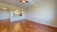 Located at 103 Patriot Dr in Middletown, Delaware, this single-floor residence offers a well-designed layout that balances functionality with comfort. Warm hardwood flooring runs consistently throughout the space, lending a cohesive and inviting feel to every room.

The kitchen is a standout feature, outfitted with crisp white shaker cabinetry, granite countertops, and a full suite of stainless steel appliances including a gas range, over-the-range microwave, dishwasher, and a large French door refrigerator. A pass-through opening connects the kitchen directly to the living area, creating an open, airy flow ideal for everyday living and entertaining.

The living area is generously proportioned, bathed in natural light from large double-pane windows dressed with blinds. A ceiling fan overhead adds to the room's comfort. The bedrooms continue the same hardwood flooring and bright, neutral palette, each equipped with ceiling fans and windows that frame outdoor views of the surrounding neighborhood.

The bathroom features a soaking tub and shower combination, accented by elegant marble-style tile surround, chrome fixtures, and accessibility grab bars — combining both style and practicality. Neutral wall tones throughout the unit create a clean, versatile backdrop ready for personalization.