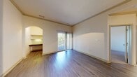 This 730 square foot apartment in Tewksbury, MA, offers a thoughtful layout with two bedrooms and one bathroom. The space is characterized by its modern design elements, including arched entryways and a mix of flooring types. The main living area features wood-look flooring, creating a seamless flow between the kitchen and living room. The kitchen boasts stainless steel appliances and wooden cabinetry, offering both functionality and style.

The primary bedroom, measuring 140 square feet, is equipped with a ceiling fan and plush carpeting, providing comfort and climate control. The bathroom showcases a contemporary design with a vanity, large mirror, and multicolored slate flooring. Convenience is key in this apartment, with an in-unit laundry room featuring full-sized appliances.

Additional amenities include a balcony, perfect for enjoying outdoor views, and a closet for extra storage. The apartment's neutral color palette and ample natural light create a bright, welcoming atmosphere throughout. Located in the Lodge At Ames Pond complex, this efficiently designed space offers modern living in a prime location.