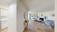 Located at 1770 N Green Valley Parkway in Las Vegas, NV, this thoughtfully designed 2-bedroom, 2-bathroom residence offers a comfortable and cohesive single-level layout. Light wood-style flooring runs throughout the home, creating a warm, unified aesthetic from room to room.

The open living area serves as the heart of the home, featuring a fireplace framed by a mirror above the mantle and large windows that invite generous natural light. The space flows seamlessly into a dedicated dining area outfitted with a ceiling fan and access to additional natural light through patio-facing windows.

The galley-style kitchen is efficiently arranged with white shaker cabinetry, white countertops, and a full suite of stainless steel appliances including a gas range, over-the-range microwave, and refrigerator. A double-door closet provides convenient in-unit storage.

Both bedrooms are well-sized and bright. The primary bedroom accommodates a queen or king bed comfortably and features a window with sheer drapery for soft, diffused light. The second bedroom benefits from corner windows, filling the room with natural light and outdoor views of the surrounding landscape.

Each of the two bathrooms features a clean, all-white design with a shower/tub combination, white vanity cabinetry, and light wood-style flooring. A hallway and dedicated closet complete the home's functional layout.