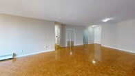 Located at 1276 Islington Ave in Toronto's Etobicoke neighbourhood, this well-appointed unit offers three bedrooms, two bathrooms, and a thoughtfully laid-out single-floor plan. Warm parquet flooring runs consistently throughout the living areas and bedrooms, lending a classic character to the space. The generously proportioned primary bedroom stands out as a notable highlight, offering an expansive footprint with baseboard heating and a large window that welcomes natural light and outdoor views. The additional bedrooms are comfortably sized, each featuring the same parquet flooring, neutral wall tones, and built-in closets for practical storage. The kitchen is well-equipped with crisp white shaker-style cabinetry extending to the ceiling, dark granite countertops, a white subway tile backsplash, and stainless steel appliances, including a full-sized refrigerator and tile flooring. The bathrooms are finished with clean white tile surrounds accented by a bold black tile border, giving them a timeless, classic look. The open living area is bright and spacious, with sliding closet doors and direct access to the main entry. Baseboard heating is present throughout, ensuring consistent comfort. The overall ambiance is clean, neutral, and functional, making this a highly livable space.