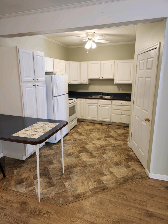 The kitchen boasts ample cabinets, a convenient kitchen island, and a spacious storage pantry - 224 River Rd